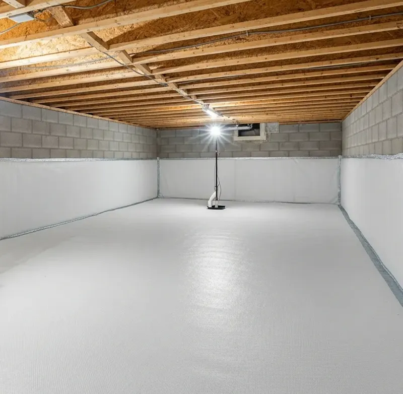 Dry basement with a white wall liner along the foundation walls, serving homeowners in Natick, MA